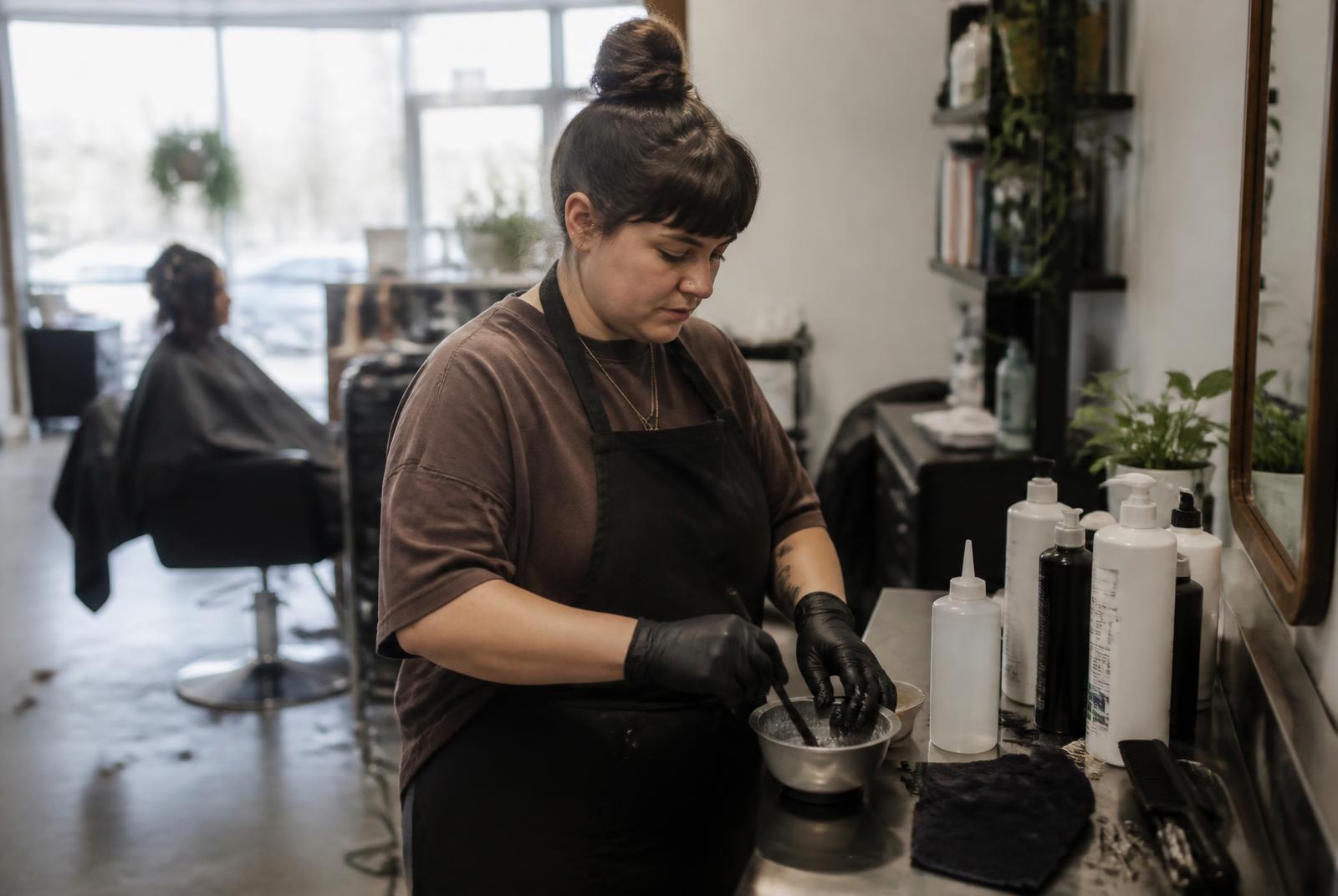 Colourist mixing a bowl at the back bar of a salon